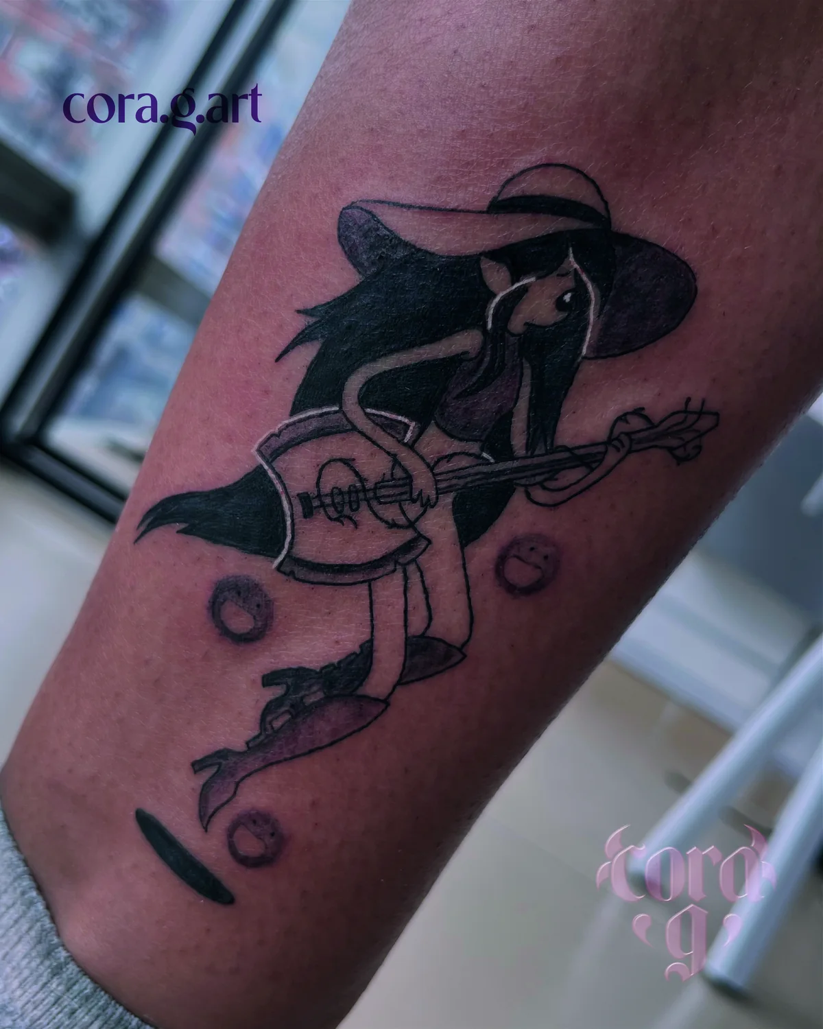 Blackwork frog playing a banjo tattoo by Cora G at Garavatto